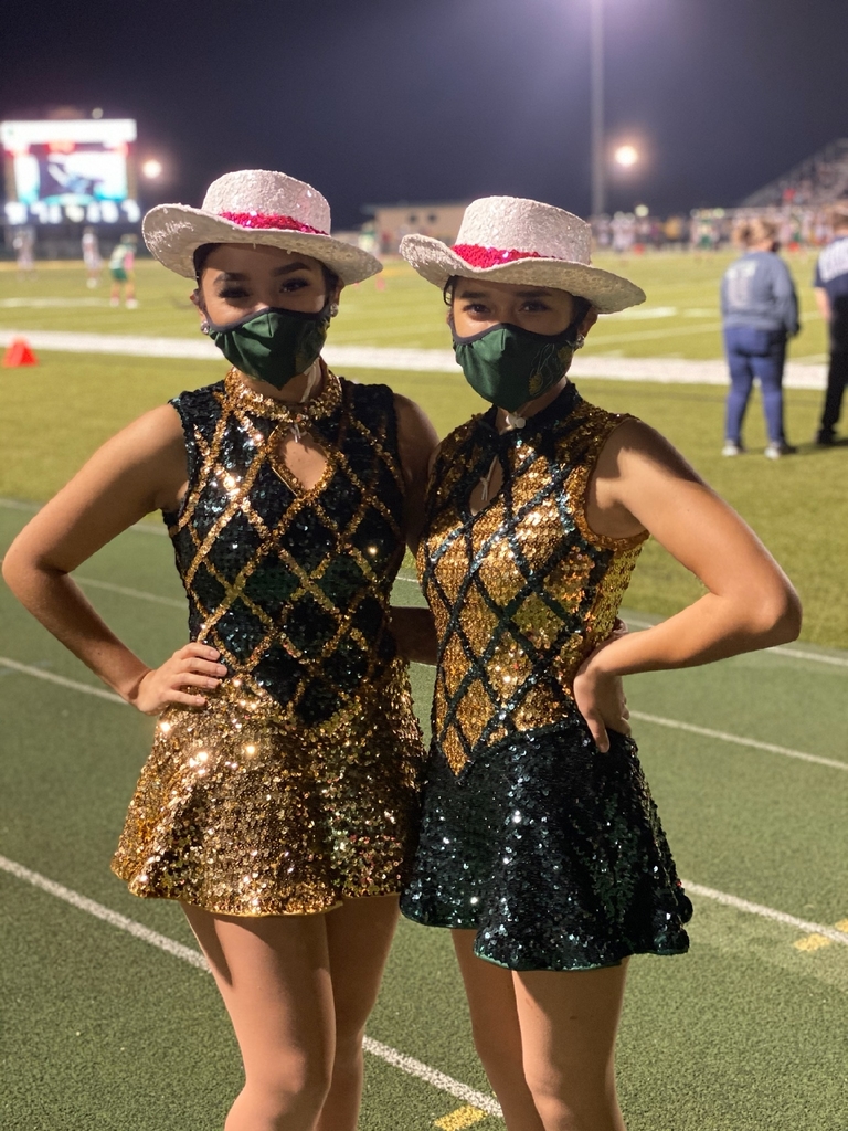 two drill team members standing on a track