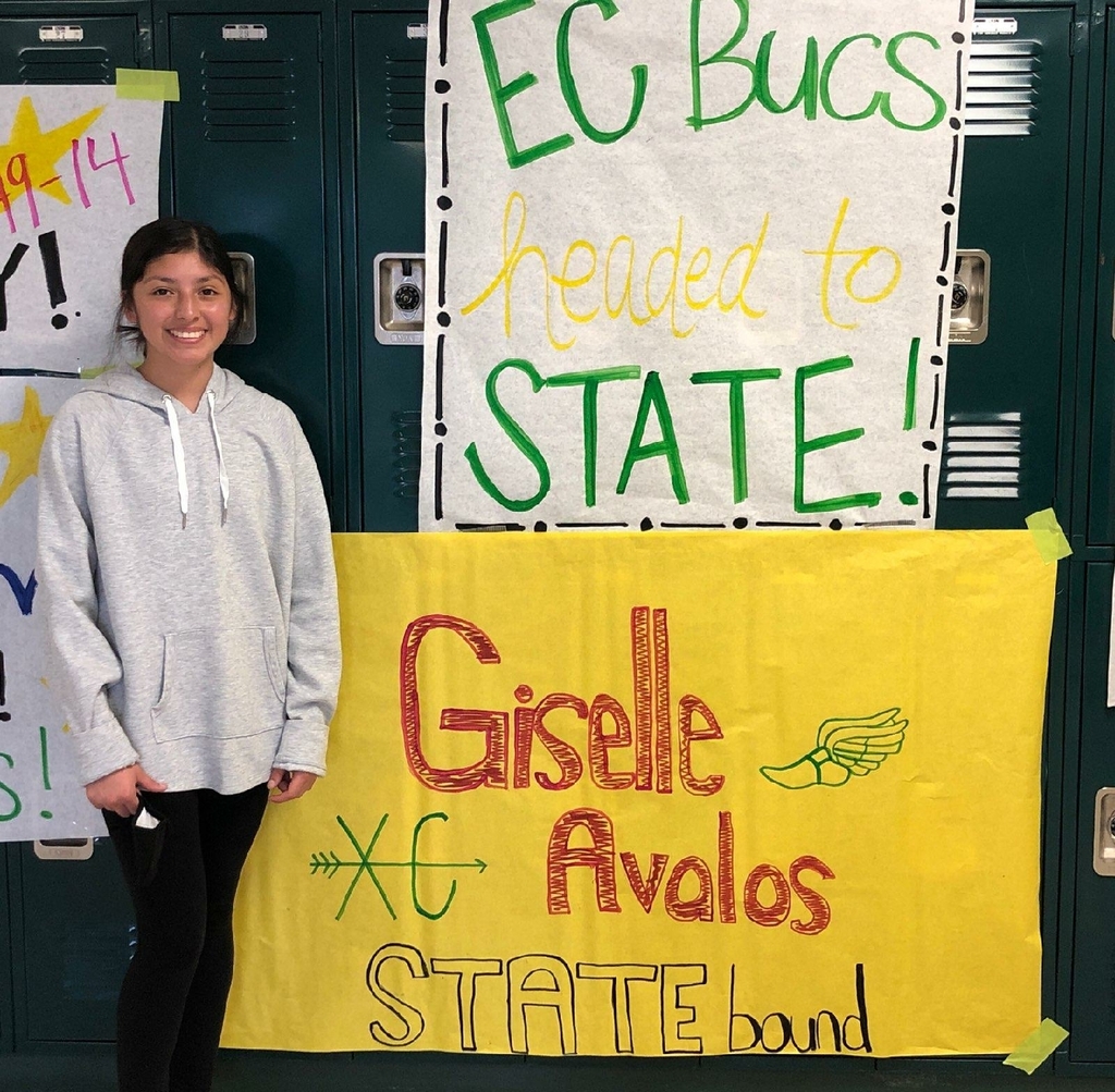 girl standing next to signs
